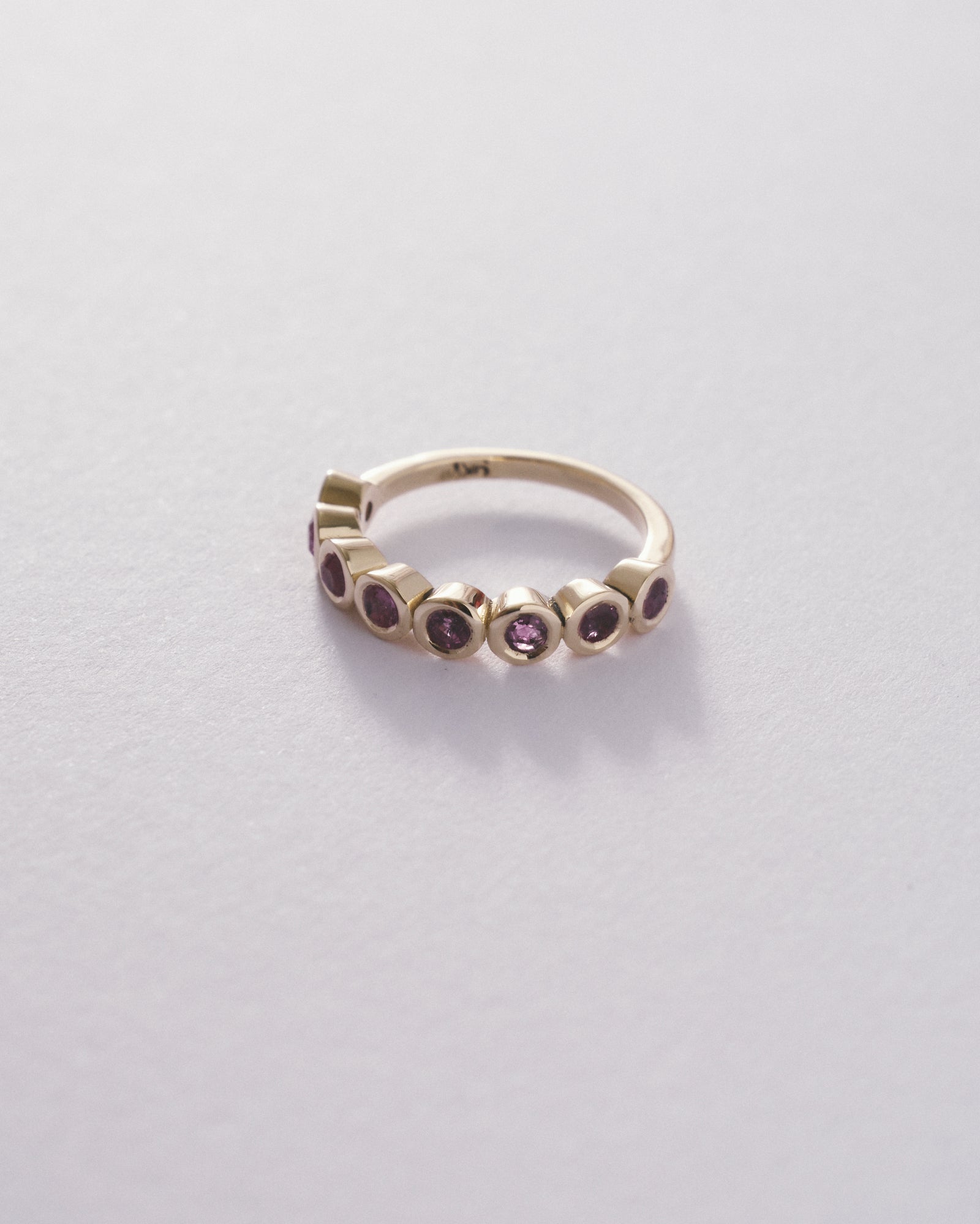 Pink sapphire bezel half eternity
