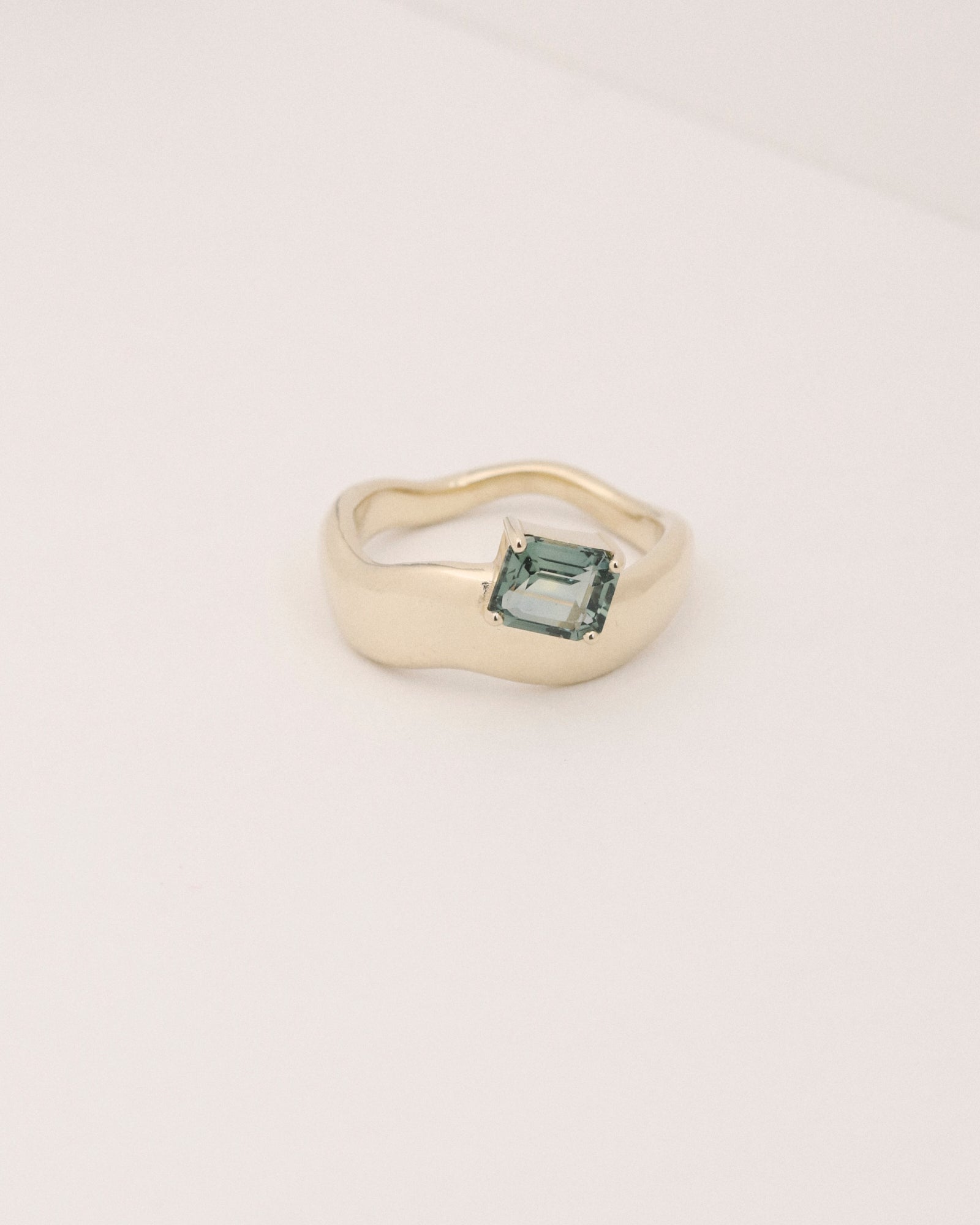 1.142ct sea-foam green emerald cut sapphire wave solitaire