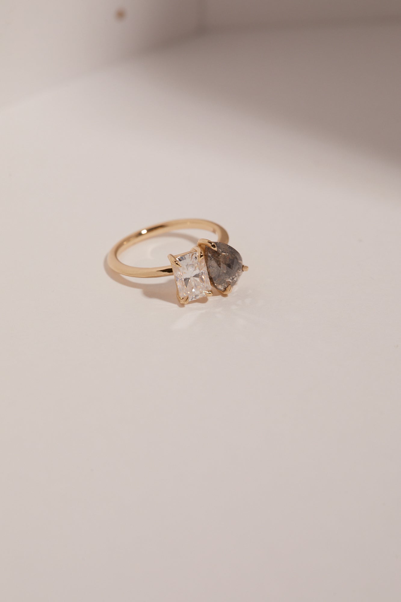 1.223ct pear cut salt and pepper diamond and 1.20ct radiant cut moissanite engagement ring.