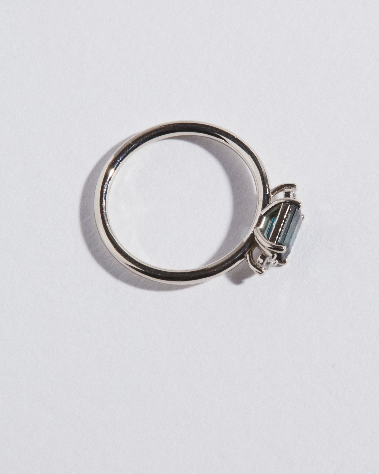 0.71ct emerald cut teal sapphire trilogy.