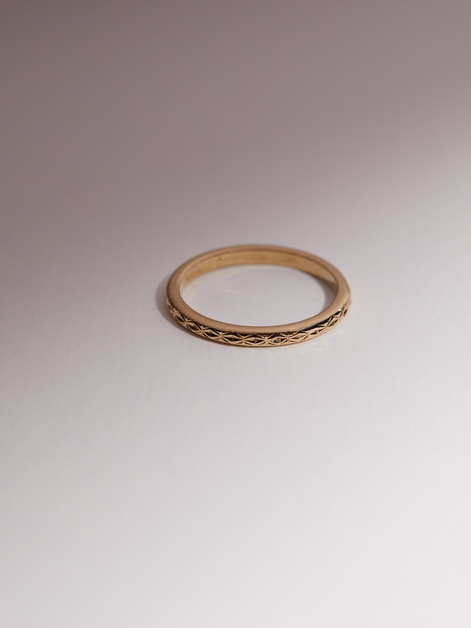 Geometric hand engraved wedding band.