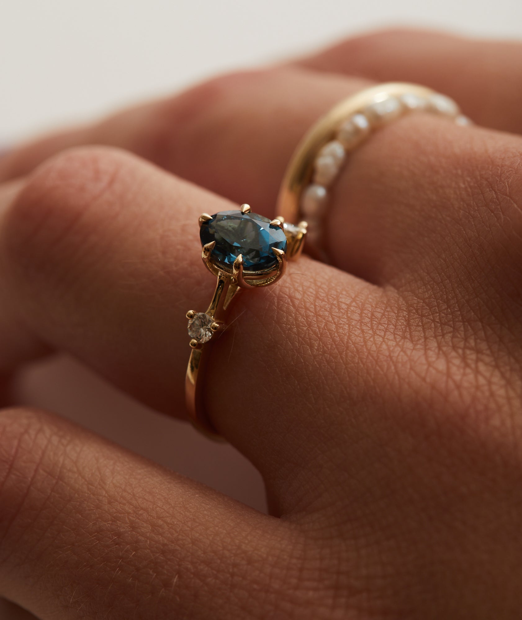 8x6mm oval cut London blue topaz and 0.10ct diamond trilogy.