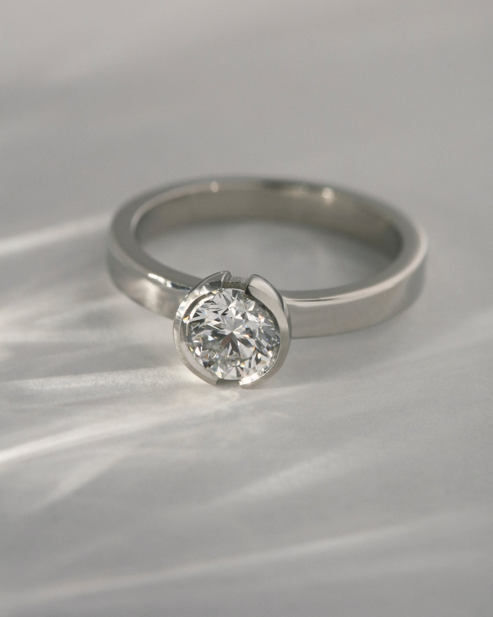 0.84ct round cut open bezel solitaire