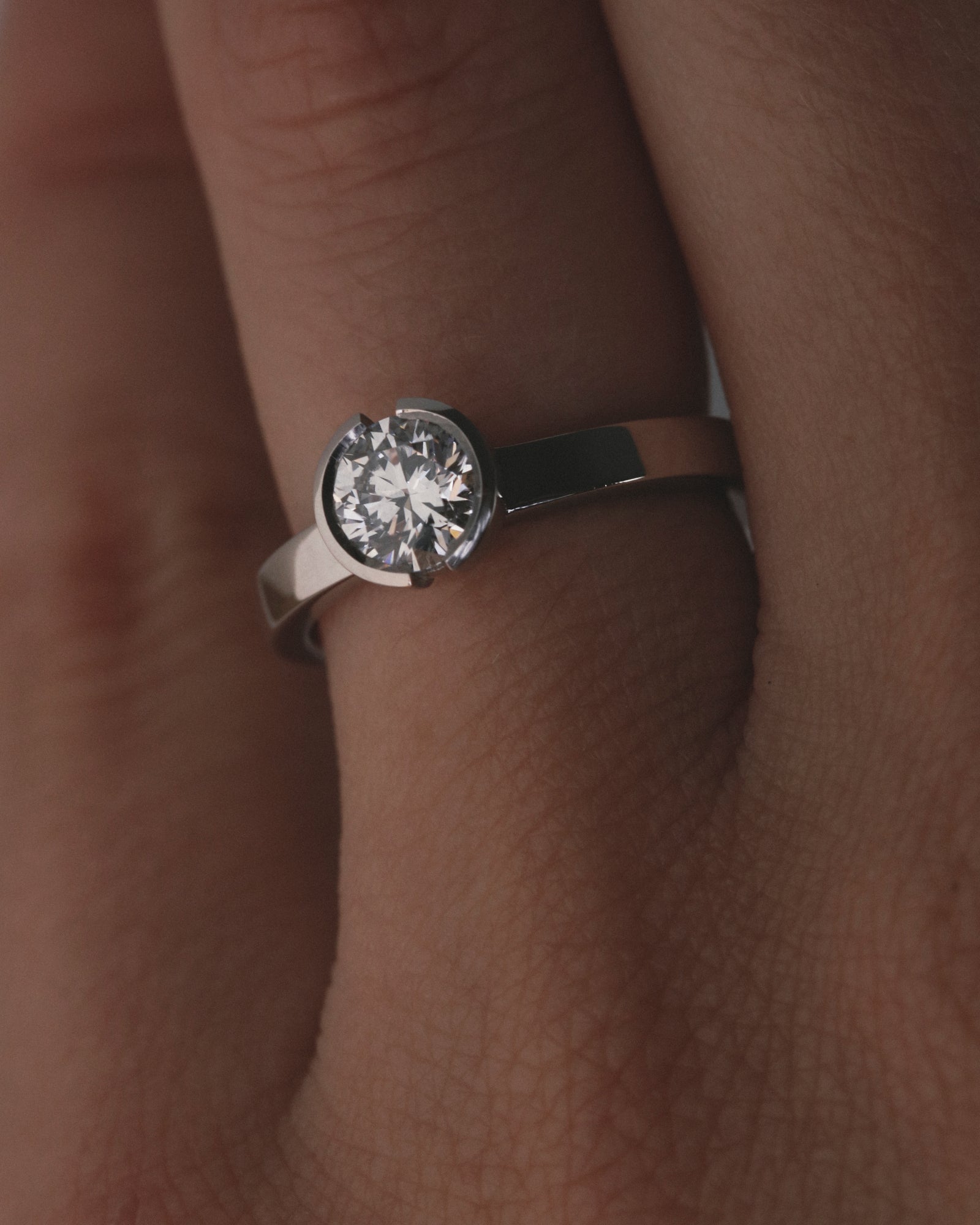 0.84ct round cut open bezel solitaire