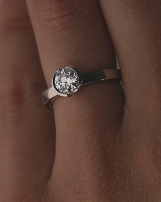 0.84ct round cut open bezel solitaire