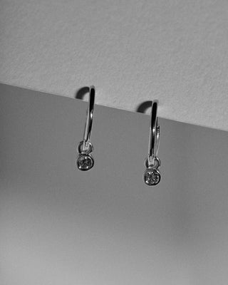 Small hinged hoops with diamond charms