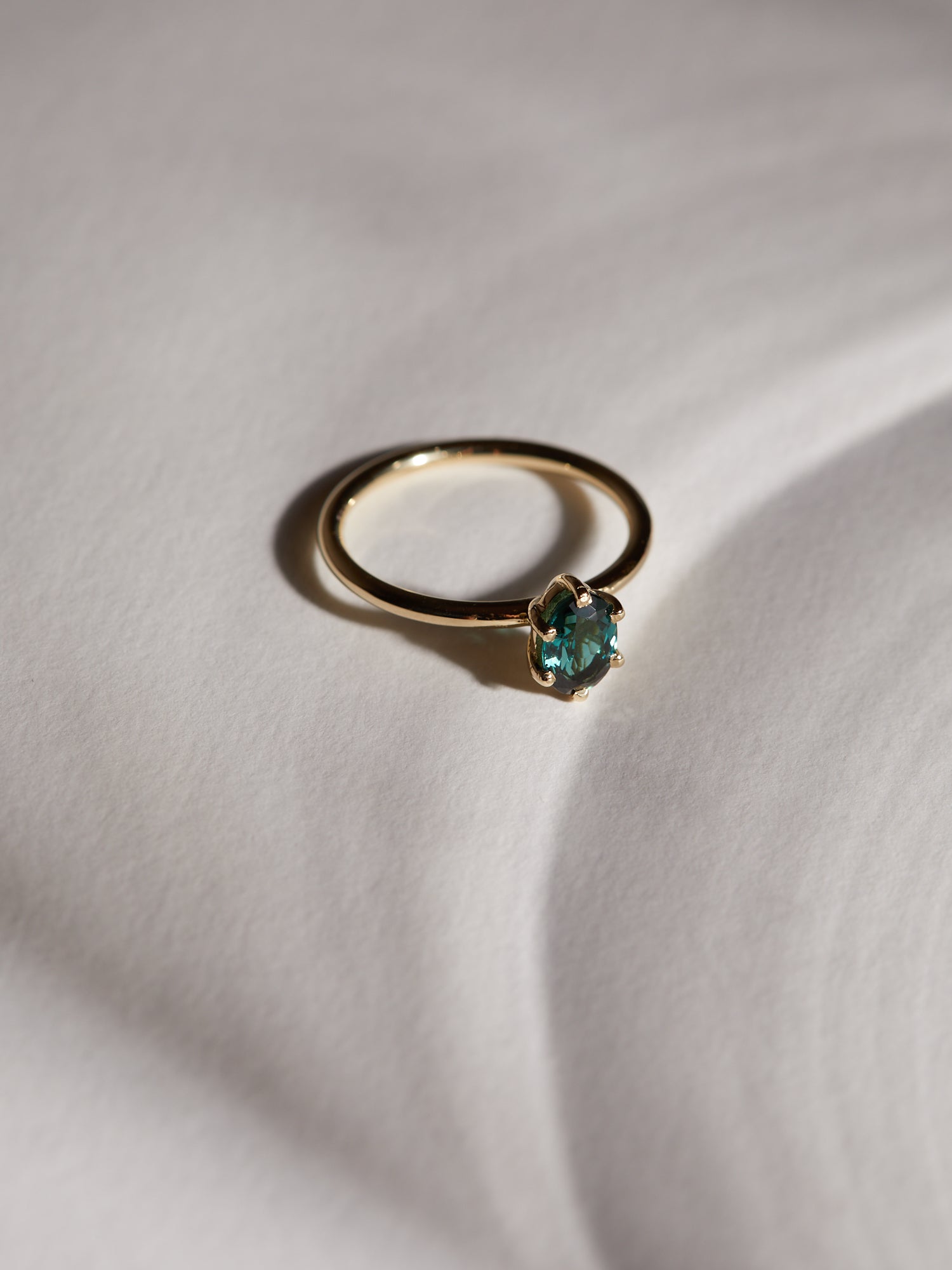 0.83ct Oval teal tourmaline solitaire.